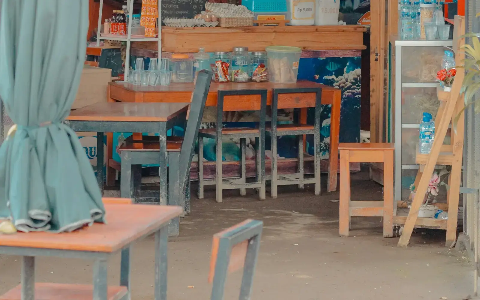 A local coffee shop in Indonesia with tables and chairs for customers