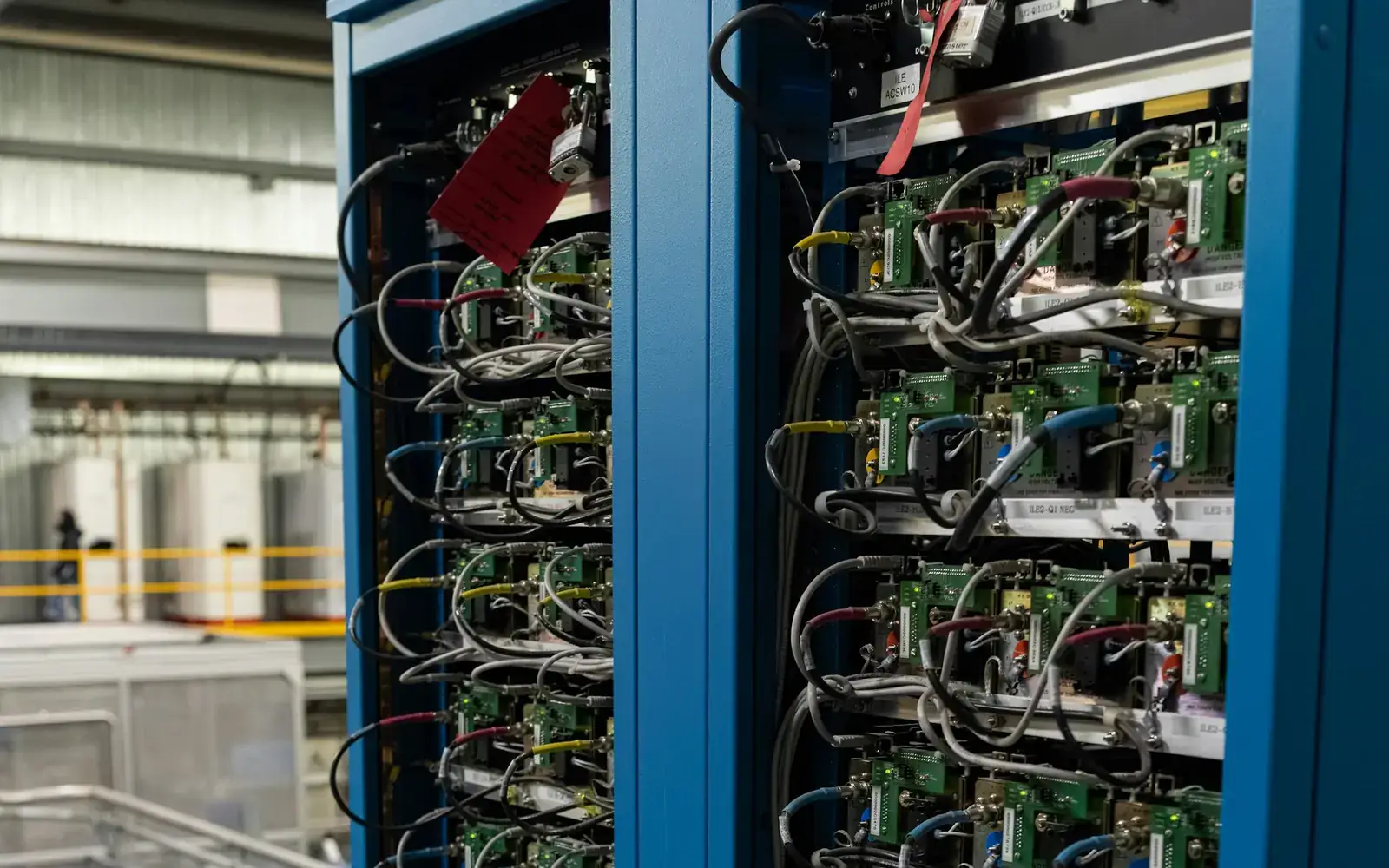 Two computing equipment racks with components and network cables