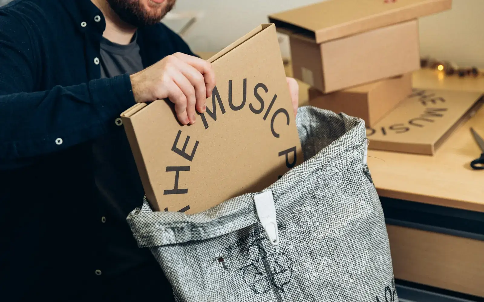 A business owner preparing an order box for shipping