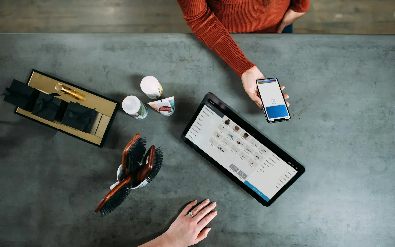 Discussing business solutions using a phone and tablet at a desk