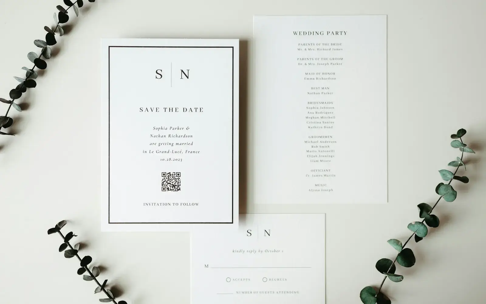 Wedding invitation cards arranged with greenery